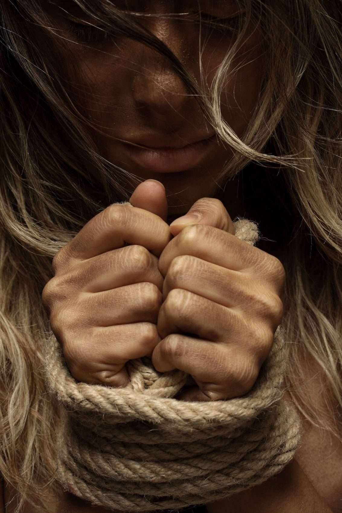 Girl with wrists in rope